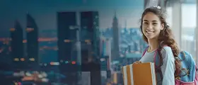 Smiling student holding books with a city skyline in the background.