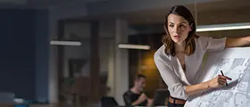 Woman presenting design plans in a modern office.