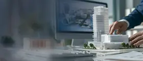 Architect working on building model with 3D design software
