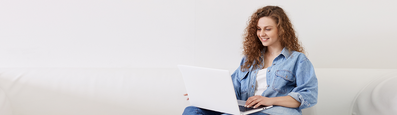 A CHRM Student sitting infront of a laptop and attending the course  in a white background
