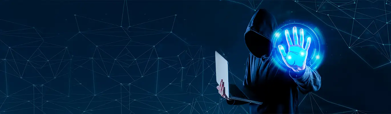 A hacker wearing hoodie standing in a dark environment with a laptop in hand while his other hand seen as touching on a transparent screen
