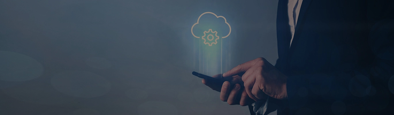 A cloud computing professional using a mobile phone from which the image of a cloud is projecting upwards