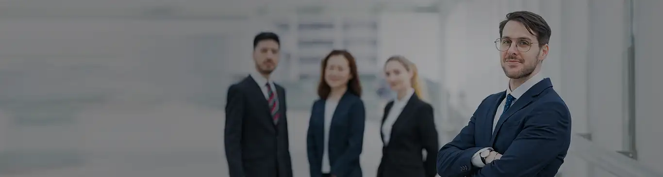 Four HR professionals standing facing the camera, one standing infront with folded hands and others behind him