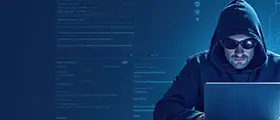 Person in a hoodie and sunglasses using a laptop with code and cybersecurity graphics in the background.