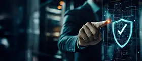 A businessman in a suit interacts with a digital security interface displaying a shield and checkmark, symbolizing cybersecurity or data protection.