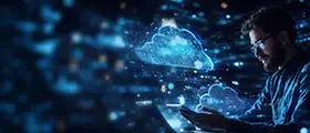 Person working on laptop with digital cloud icons representing cloud computing and data technology.