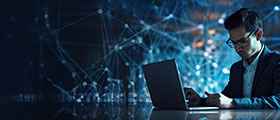 Man working on laptop with digital network graphics in background, representing tech and IT training.