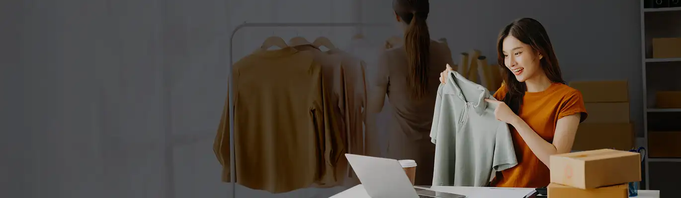 Professional fashion designer looking for clothing with a laptop