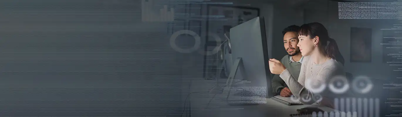 two Full Stack Developers discussing in front of a system
