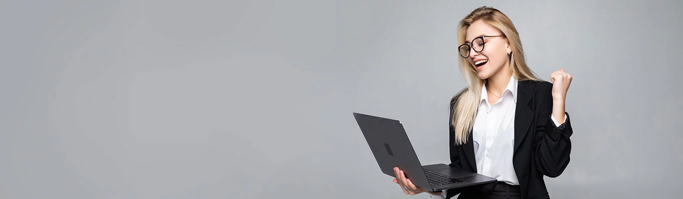 An accountant standing with a laptop in hand