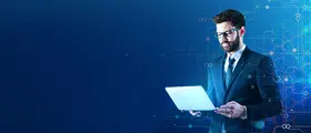 A professional man in a suit using a laptop against a blue digital technology background.