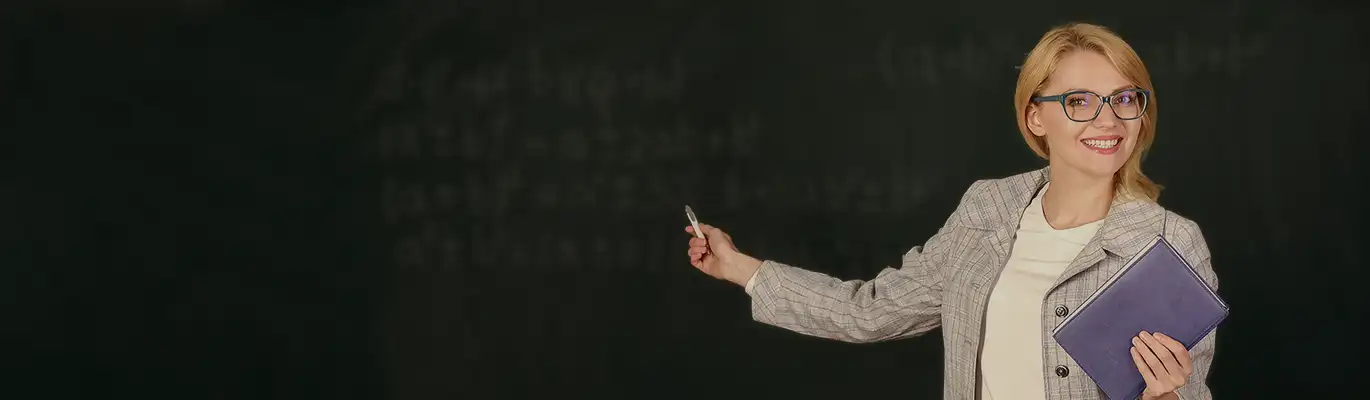 Spoken English professional standing holding a laptop on hand
