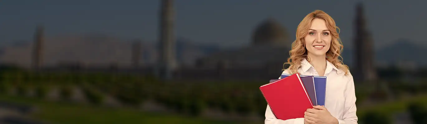 A Spoken english trainer standing with a book 