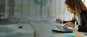 Woman working on accounting software with a color-coded keyboard in office