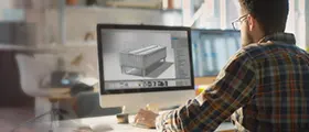 Man working on 3D rendering software on a desktop computer, representing a V-Ray course.  