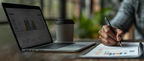 Zoho accounting professional looking on charts while using a laptop 