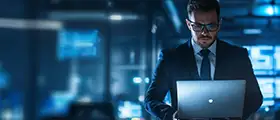 Professional Azure Security Engineer Associate (AZ-500) working on a laptop in a secure, high-tech environment with digital data displays in the background.