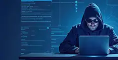 An ethical hacker working on a laptop, a blue print image of security lock icon is seen as pops up from the laptop screen