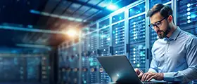 Professional IT specialist working on a laptop in a secure data center with illuminated server racks, symbolizing advanced cybersecurity expertise through CompTIA CASP+ certification.