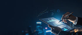 Data analytics professional reviewing digital reports and dashboards on tablet.