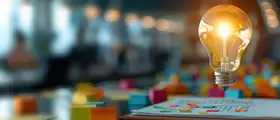 A glowing light bulb floating above design charts and colorful sticky notes on a desk, symbolizing creativity and innovation.