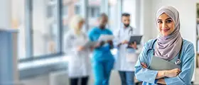 ChatGPT said:  Professional DHA-certified healthcare worker standing confidently in a hospital environment.