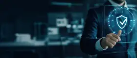 A professional in formal attire interacting with a digital shield interface, representing advanced cybersecurity expertise and professional ECIH (EC-Council Certified Incident Handler) training.
