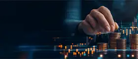 Hand placing coins in ascending stacks against a digital stock market chart, illustrating wealth accumulation, financial forecasting, and investment strategy.