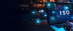 Professional working on laptop with ISO/IEC 27002 cybersecurity and data protection icons.