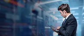 Professional working on tablet in data center environment for Redis course certification.