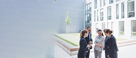 Sales professionals discussing property strategies during a real estate training session