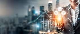 Professional business executive presenting digital financial analytics with charts, graphs, and strategic growth icons against a modern city skyline background.