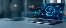 Laptop displaying cloud computing and data storage icons on screen in a modern office setting.