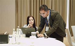 Mentor Manish assisting a participant with a laptop exercise during Edoxi's Artificial Intelligence (AI) corporate training at DoubleTree by Hilton, Dubai