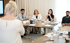 Corporate professionals participating in Edoxi's Assertive Career Excellence training session focused on communication and career development at Al Jaddaf Rotana Hotel, Dubai.